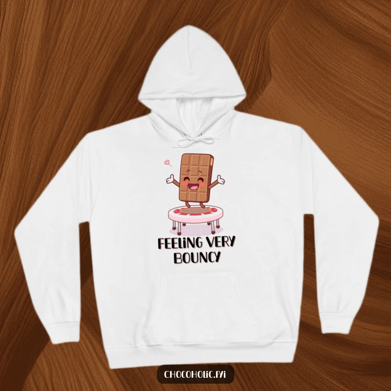 Funny hoodie showing a chocolate bar character bouncing high on a marshmallow trampoline, arms wide open in a gesture of pure joy.